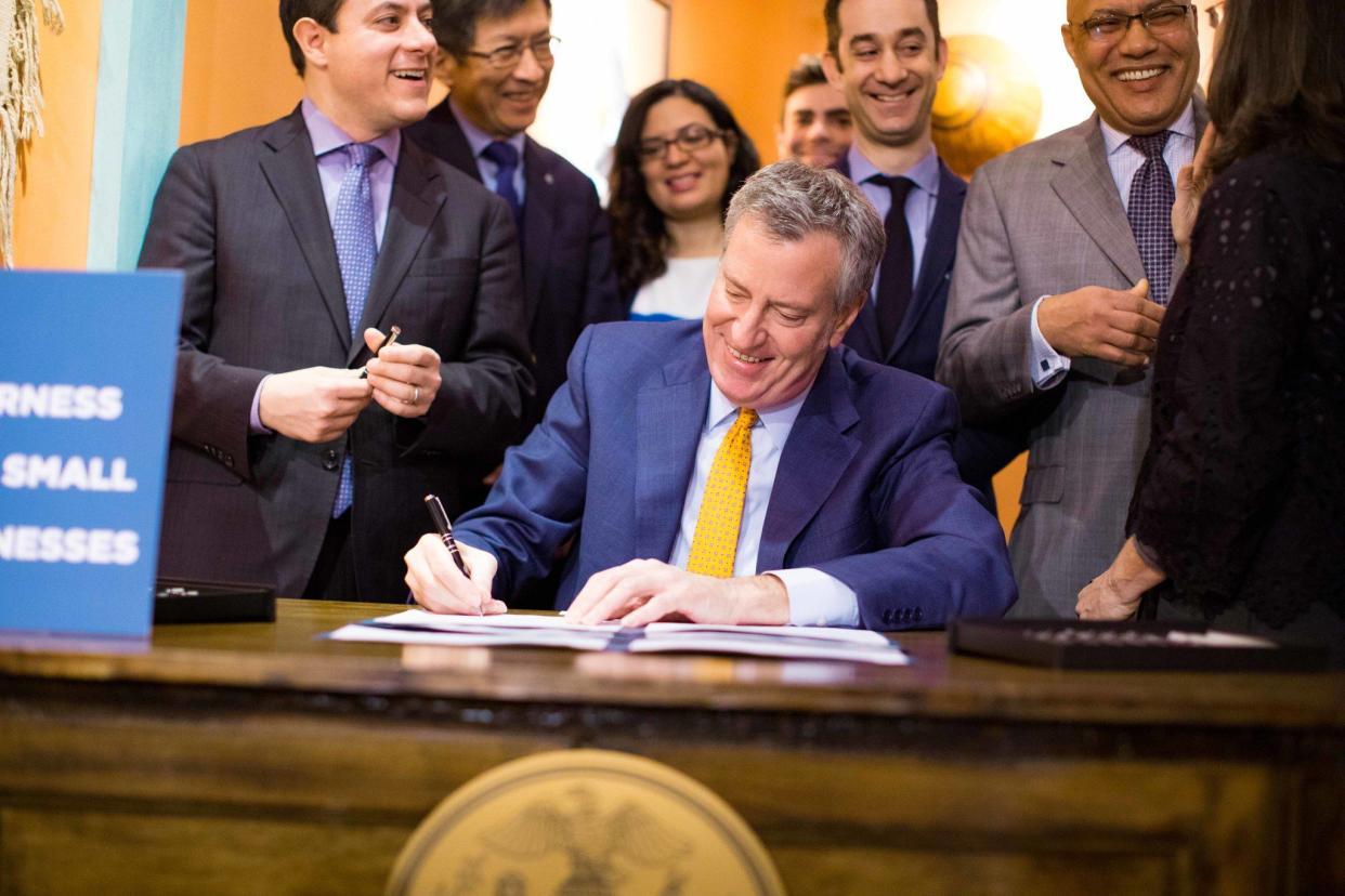 New York City Mayor Bill de Blasio signs Intros. 799-B, 1376-A and 1783 to provide commercial rent tax relief for certain small business owners and study the impact of the commercial rent tax at Santa Fe, an Upper West Side restaurant on December 22, 2017.