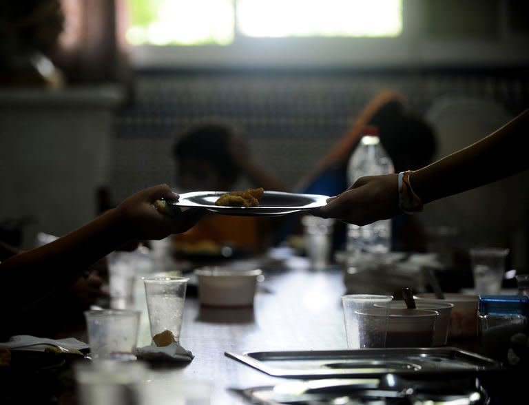 Children eat during school time in the Parish of San Antonio Abab, in Sevilla, on August 29, 2013. Welfare groups warn that many children are suffering in Spain after five years of on-off recession