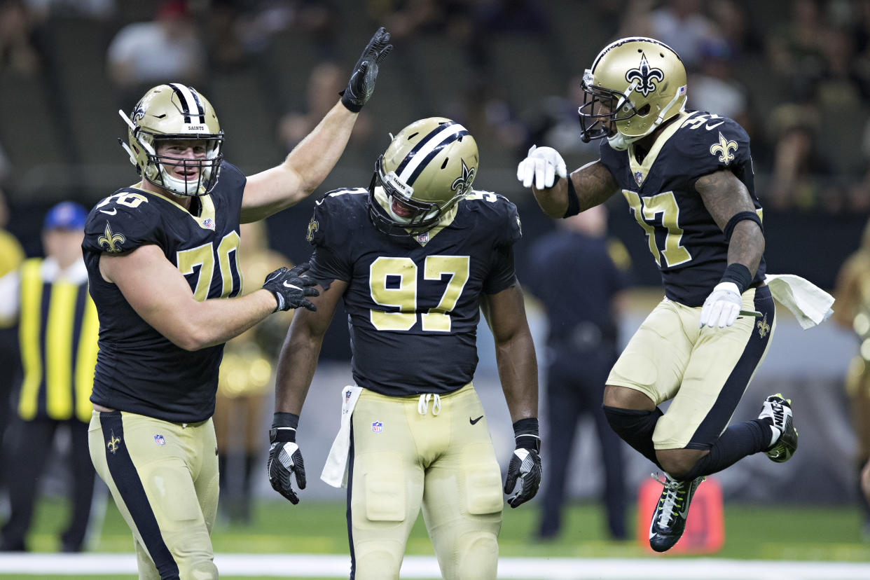 Saints defensive lineman Mitchell Loewen, left, helped rescue a man who was trapped in his car after it fell from the fourth floor of a New Orleans parking garage on Sunday. (Getty Images)