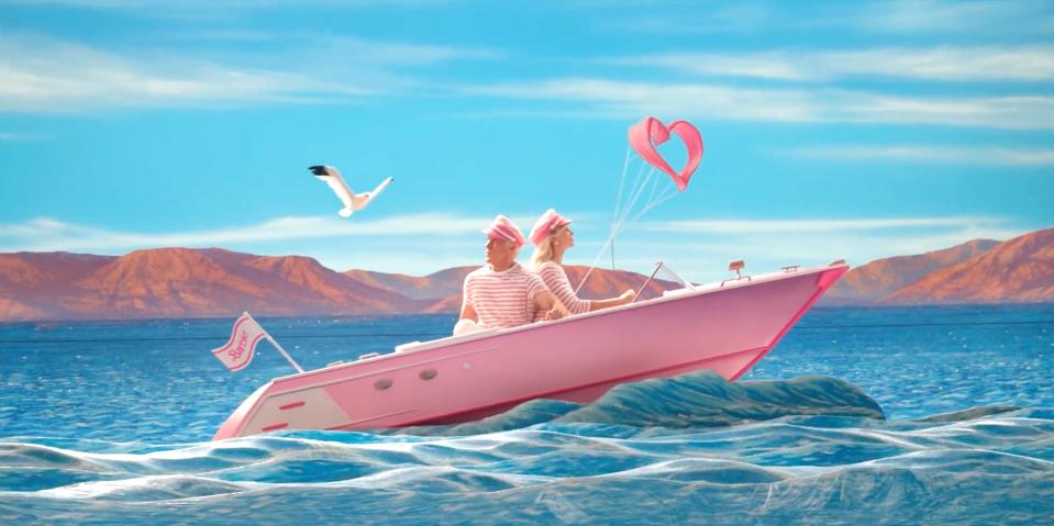 A scene from "Barbie" where Barbie and Ken are driving a speedboat across the ocean while a seagull flies above them.