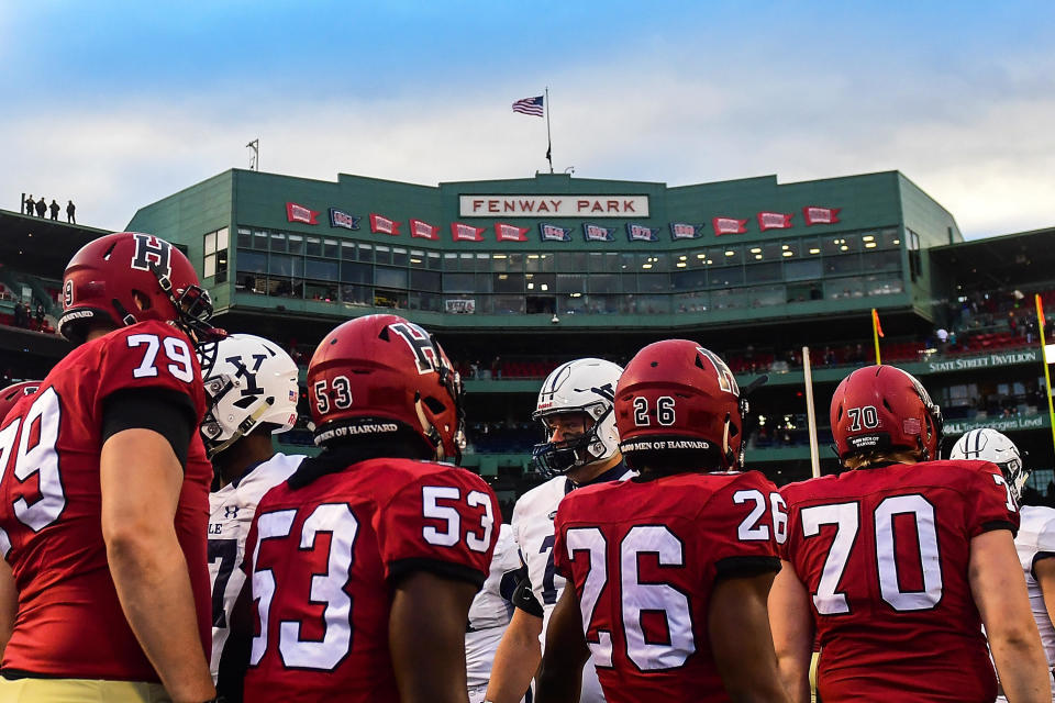 The Harvard Crimson and the Yale Bulldogs shake hands after a game at Fenway Park on November 17, 2018, in Boston. / Credit: Adam Glanzman / Getty