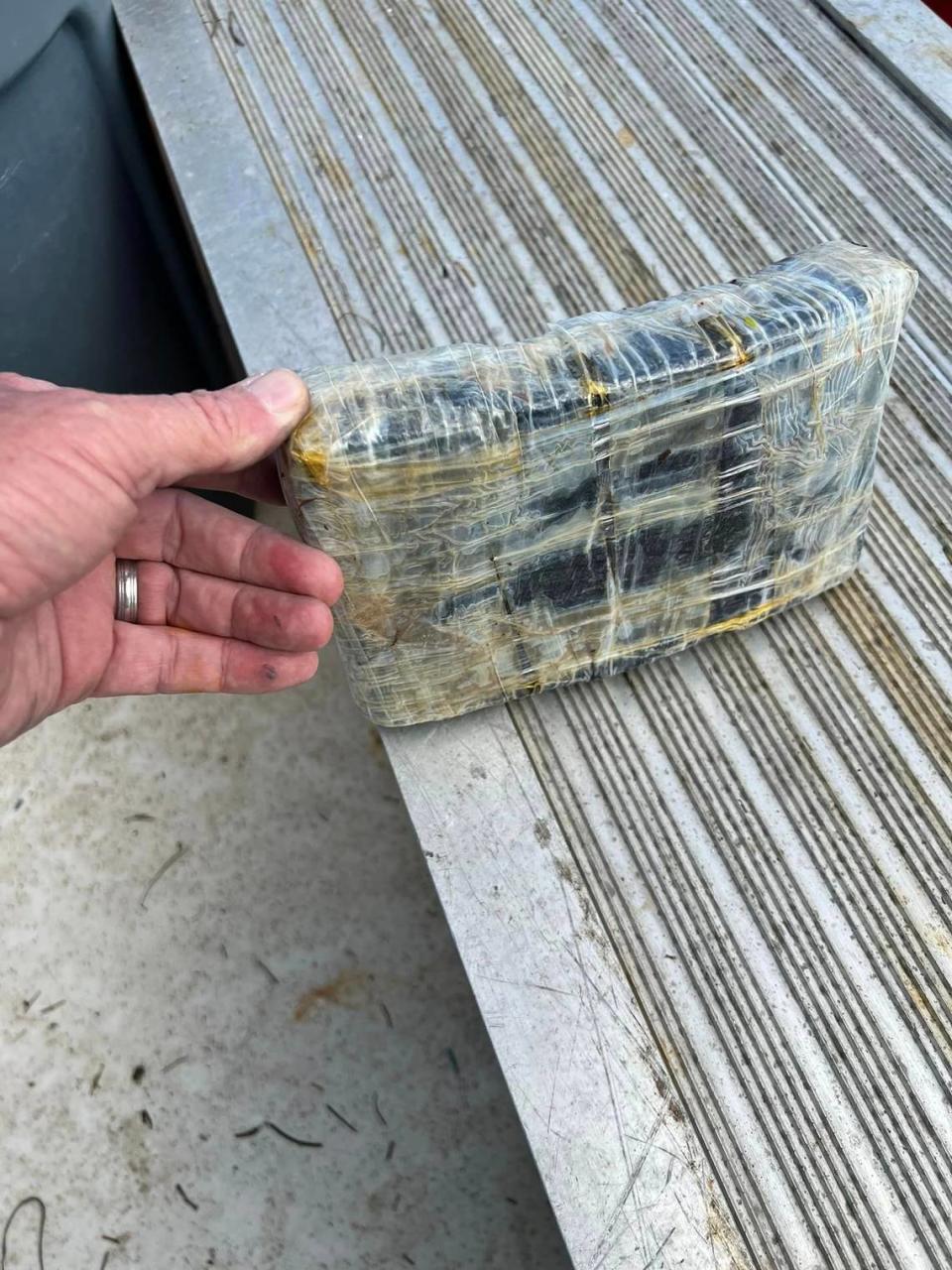 A brick of cocaine found by volunteers cleaning trash in the mangroves of Big Pine Key Monday, Jan. 29, 2024, is displayed on a table.