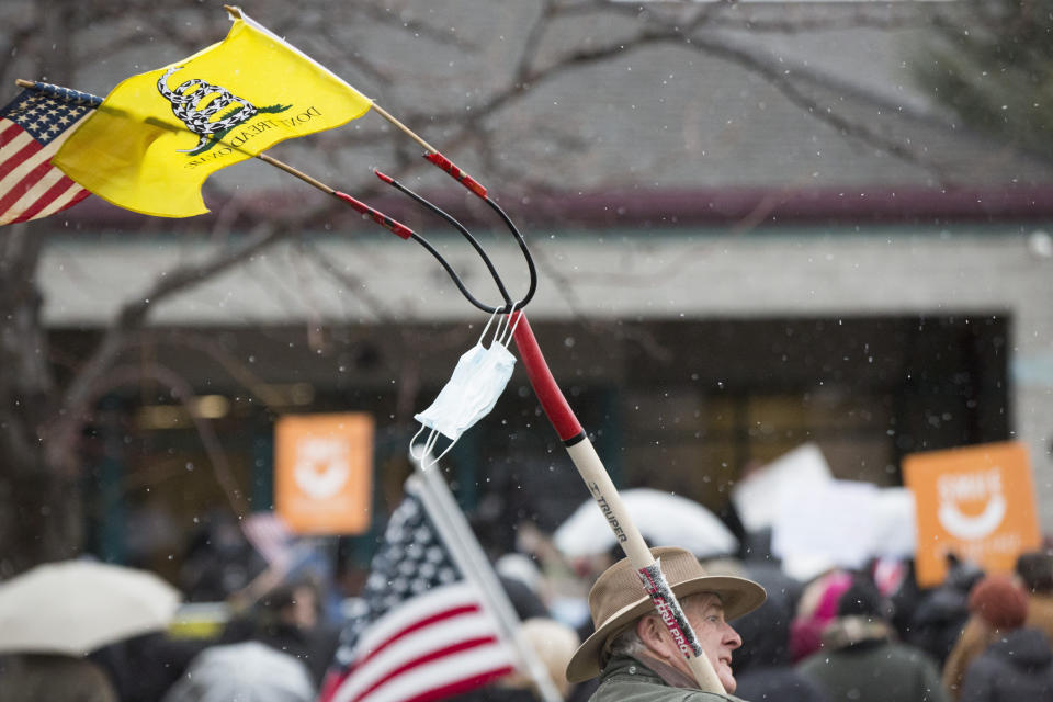 Protesters gather outside Central District Health's office in Boise, Idaho, on Tuesday, Dec. 15, 2020. A proposed public health order that would have included a mask mandate for Idaho's most populated region was voted down on Tuesday as hundreds of protesters again gathered outside the Central District Health building in Boise. (AP Photo/Otto Kitsinger)