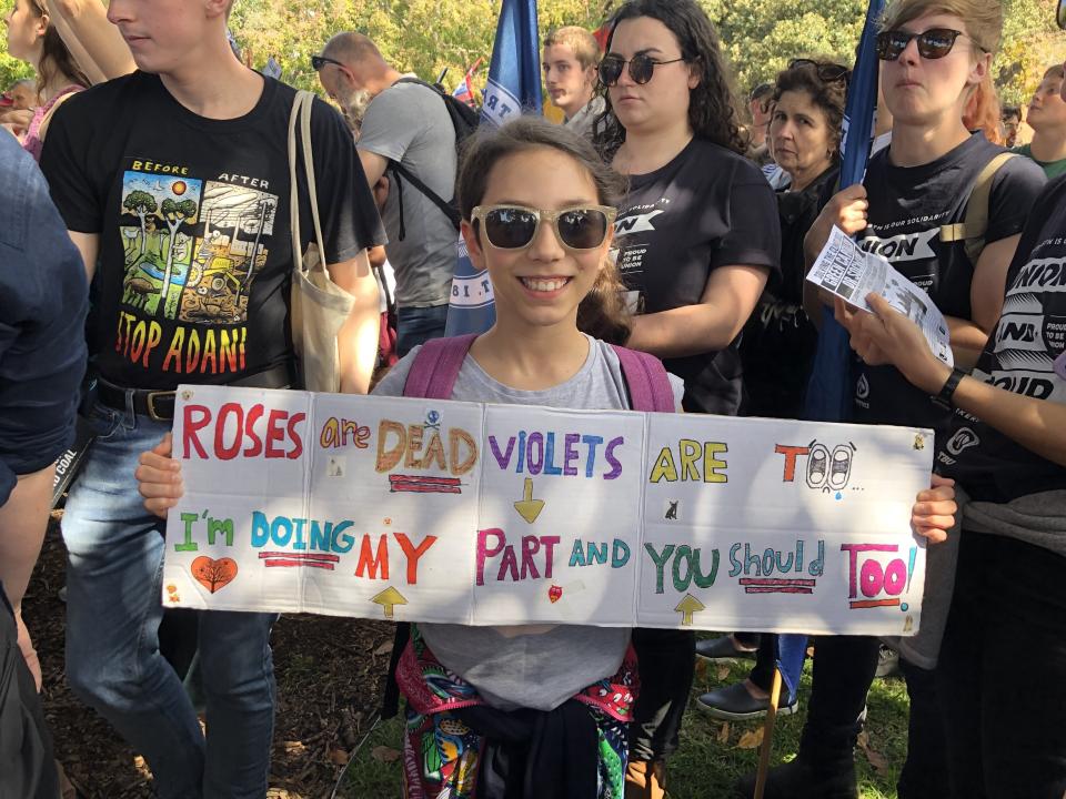 Rebecca Manuguerra, 10, holds up a sign she made for Friday's climate strike in Sydney. (Photo: Nick Visser / HuffPost)