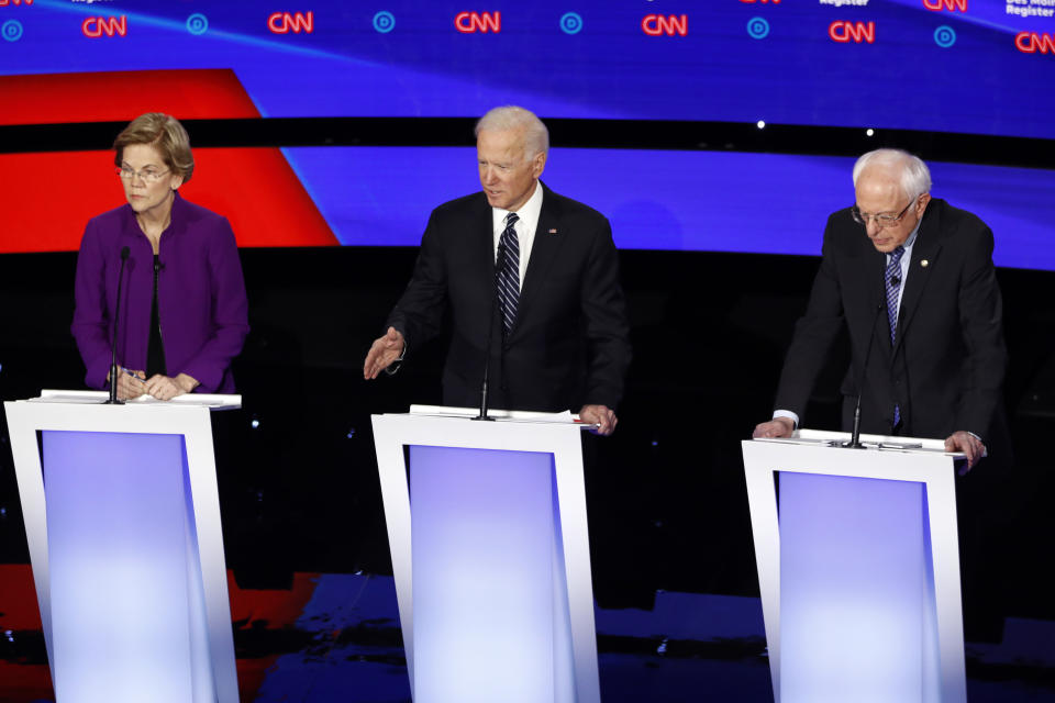 Democratic presidential candidate former Vice President Joe Biden answers a question Tuesday, Jan. 14, 2020, during a Democratic presidential primary debate hosted by CNN and the Des Moines Register in Des Moines, Iowa, as Sen. Elizabeth Warren, D-Mass., left and Sen. Bernie Sanders, I-Vt., listen. (AP Photo/Patrick Semansky)