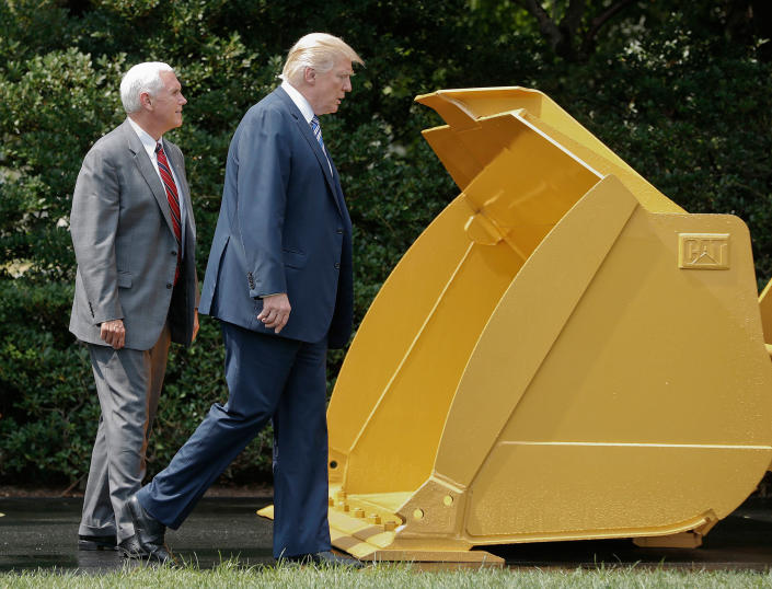 <p>President Trump and Vice President Mike Pence walk past a Caterpillar truck manufactured in Illinois on the South Lawn of the White House in Washington during a “Made in America” product showcase featuring items created in each of the 50 U.S. states on July 17, 2017. (AP Photo/Pablo Martinez Monsivais) </p>