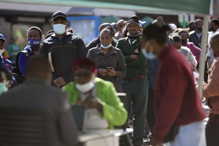 People stand in a bank queue in Harare, Monday, July 25, 2022. Zimbabwe on Monday launched gold coins to be sold to the public to try to tame runaway inflation that has further eroded the country’s unstable currency. (AP Photo/Tsvangirayi Mukwazhi)