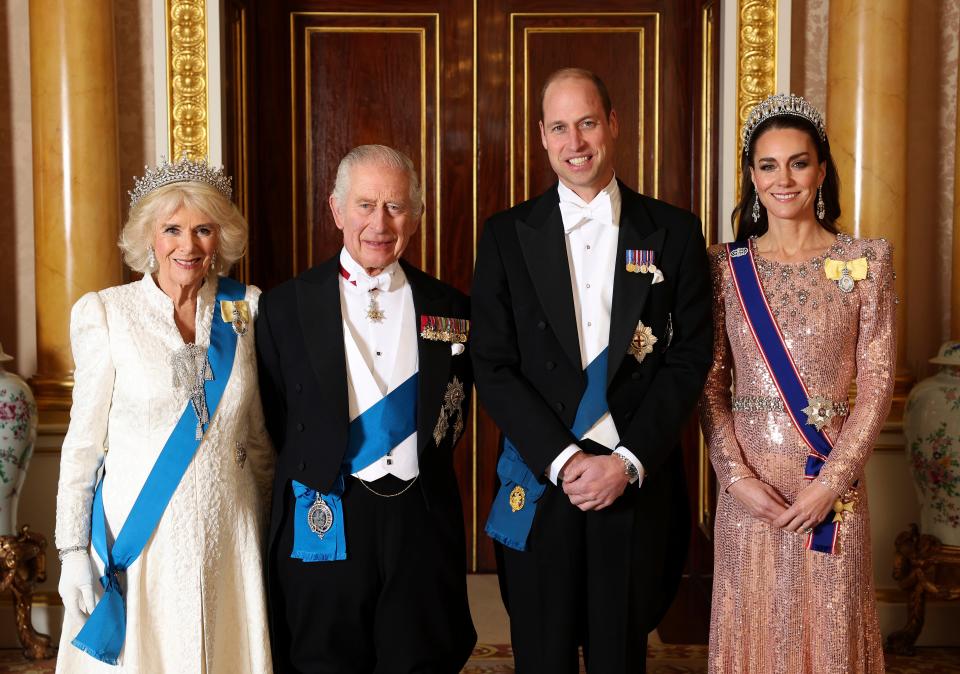 Queen Camilla, King Charles III, Prince William and Kate, Princess of Wales, pose for a photograph ahead of the Diplomatic Reception in the 1844 Room at Buckingham Palace in London on Dec. 5, 2023.