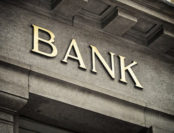 Bank sign on stone facade.