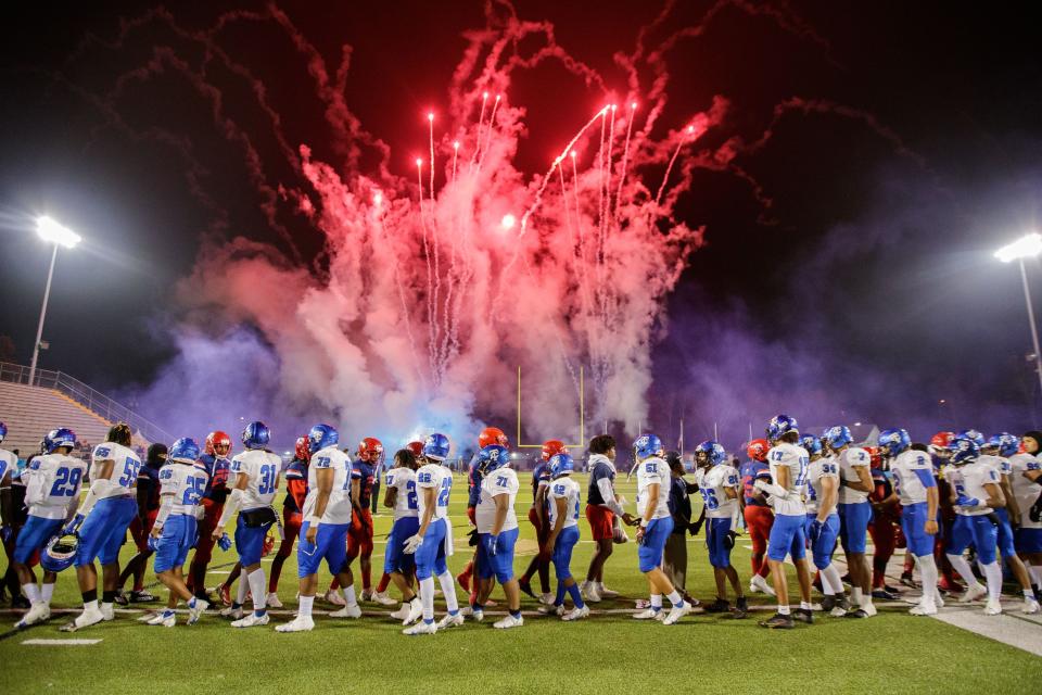 Trinity Christian players congratulate Champagnat players on a good game before celebrating their victory. Trinity Christian defeated Champagnat 41-23 to claim the Class 2A State Championship title at Gene Cox on Thursday, Dec. 9, 2021.