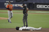 Second base umpire Jeff Nelson indicates to Tampa Bay Rays Randy Arozarena to get off the field after he was forced out by Houston Astros shortstop Carlos Correa during the third inning in Game 7 of a baseball American League Championship Series, Saturday, Oct. 17, 2020, in San Diego. (AP Photo/Jae C. Hong)