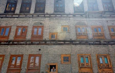 A man looks out from the window of a house during a strike called by Kashmiri separatists, against the recent killings in Kashmir, in downtown Srinagar May 6, 2018. REUTERS/Danish Ismail