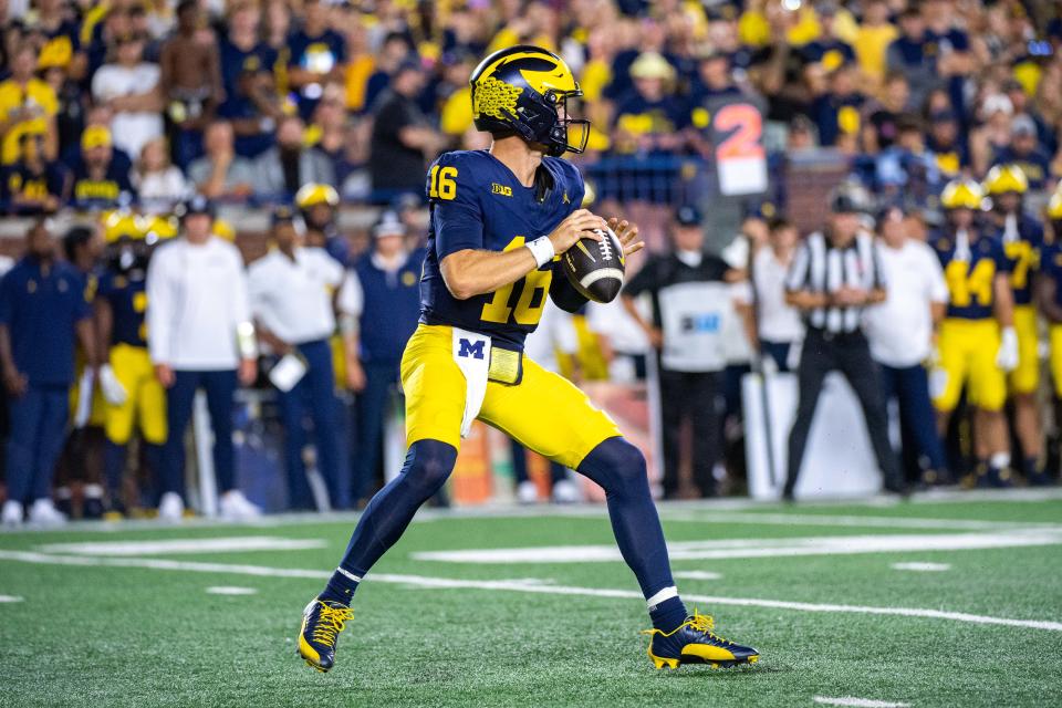 ANN ARBOR, MICHIGAN – AUGUST 31: Davis Warren #16 of the Michigan Wolverines attempts to throw the ball wide during the second half of a college football game against the Fresno St. Bulldogs at Michigan Stadium on August 31, 2024 in Ann Arbor, Michigan. The Michigan Wolverines won the game 30-10. (Photo by Aaron J. Thornton/Getty Images)