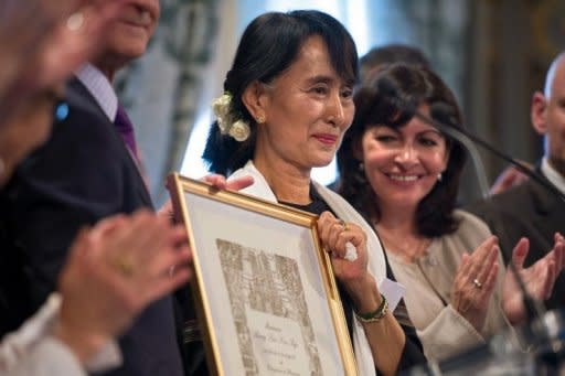 Myanmar pro-democracy leader Aung San Suu Kyi poses after receiving an honorary citizen award, beside Paris' deputy mayor Anne Hidalgo (R) at the Paris City Hall. Suu Kyi, nearing the end of her triumphant Europe tour in France, accepted another award Wednesday as she became an honorary citizen of Paris