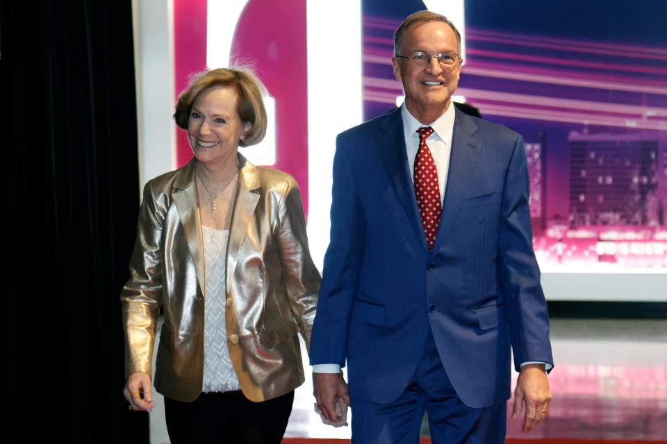 Lon Kruger, former head coach at Kansas State, Florida, Illinois, UNLV and Oklahoma, right, and his wife, Barbara, arrive at a National Collegiate Basketball Hall of Fame induction event, Sunday, Nov. 20, 2022, in Kansas City, Mo. (AP Photo/Colin E. Braley)