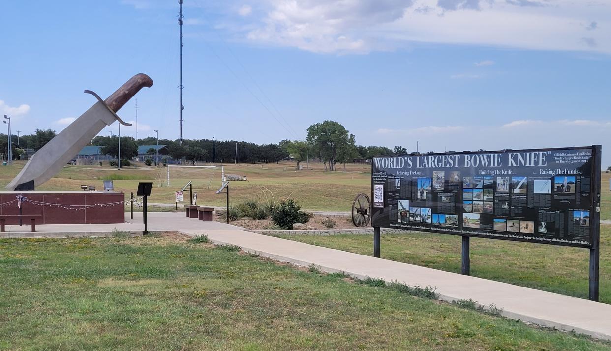 Bowie's "World's Largest Bowie Knife," seen here Aug. 5, 2023, stands on display a short distance away from a sign commemorating the process.