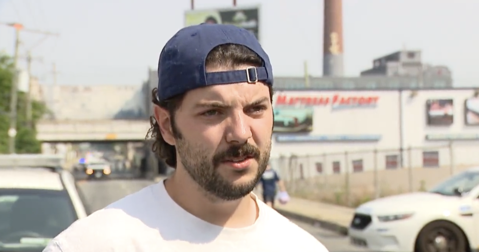 A close-up of the bearded NE Philly guy who's wearing a t-shirt and a baseball cap on backwards