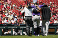 Colorado Rockies starting pitcher Antonio Senzatela (49) is helped off the field after being injured while covering first base during the second inning of a baseball game against the St. Louis Cardinals Thursday, Aug. 18, 2022, in St. Louis. Senzatela left the game. (AP Photo/Jeff Roberson)