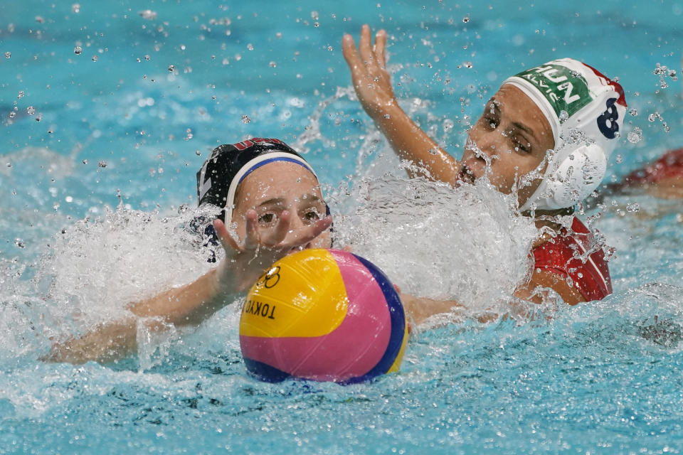 United States' Alys Williams, left, and Hungary's Rita Keszthelyi (8) reach for the ball during a preliminary round women's water polo match at the 2020 Summer Olympics, Wednesday, July 28, 2021, in Tokyo, Japan. (AP Photo/Mark Humphrey)