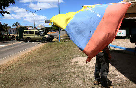 FILE PHOTO: The Venezuelan flag is seen at the scene where Venezuelan soldiers opened fire on indigenous people near the border with Brazil on Friday, according to community members, in Kumarakapay, Venezuela, February 22, 2019. REUTERS/William Urdaneta/File Photo NO RESALES. NO ARCHIVES