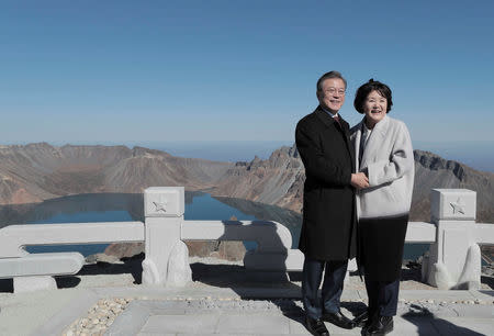 South Korean President Moon Jae-in and first lady Kim Jung-sook pose for photographs on the top of Mt. Paektu, North Korea, September 20, 2018. Pyeongyang Press Corps/Pool via REUTERS