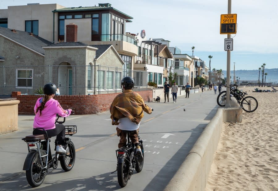 HERMOSA BEACH, CA-NOVEMBER 10, 2023, 2023:People ride an e-bike on the Strand in Hermosa Beach, going 14 mph, which is over the posted speed limit of 8 mph. In Hermosa Beach, it's against city code to use electric power on the Strand, but many e-bike riders do so anyway. (Mel Melcon / Los Angeles Times via Getty Images)