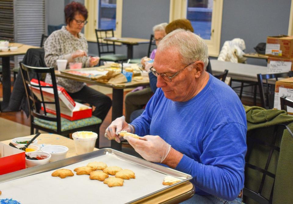 Bob Davis from Vickery spent the morning of Dec. 19 decorating cookies with other Golden Thread volunteers.