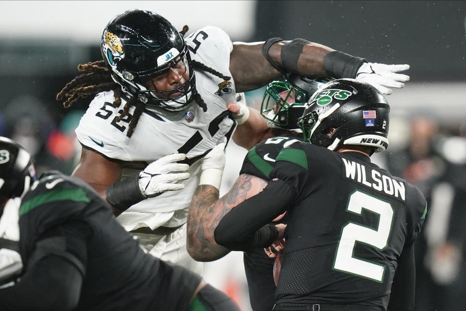 Jacksonville Jaguars defensive tackle DaVon Hamilton (52) puts pressure on New York Jets quarterback Zach Wilson (2) during the third quarter of an NFL football game, Thursday, Dec. 22, 2022, in East Rutherford, N.J. (AP Photo/Frank Franklin II)