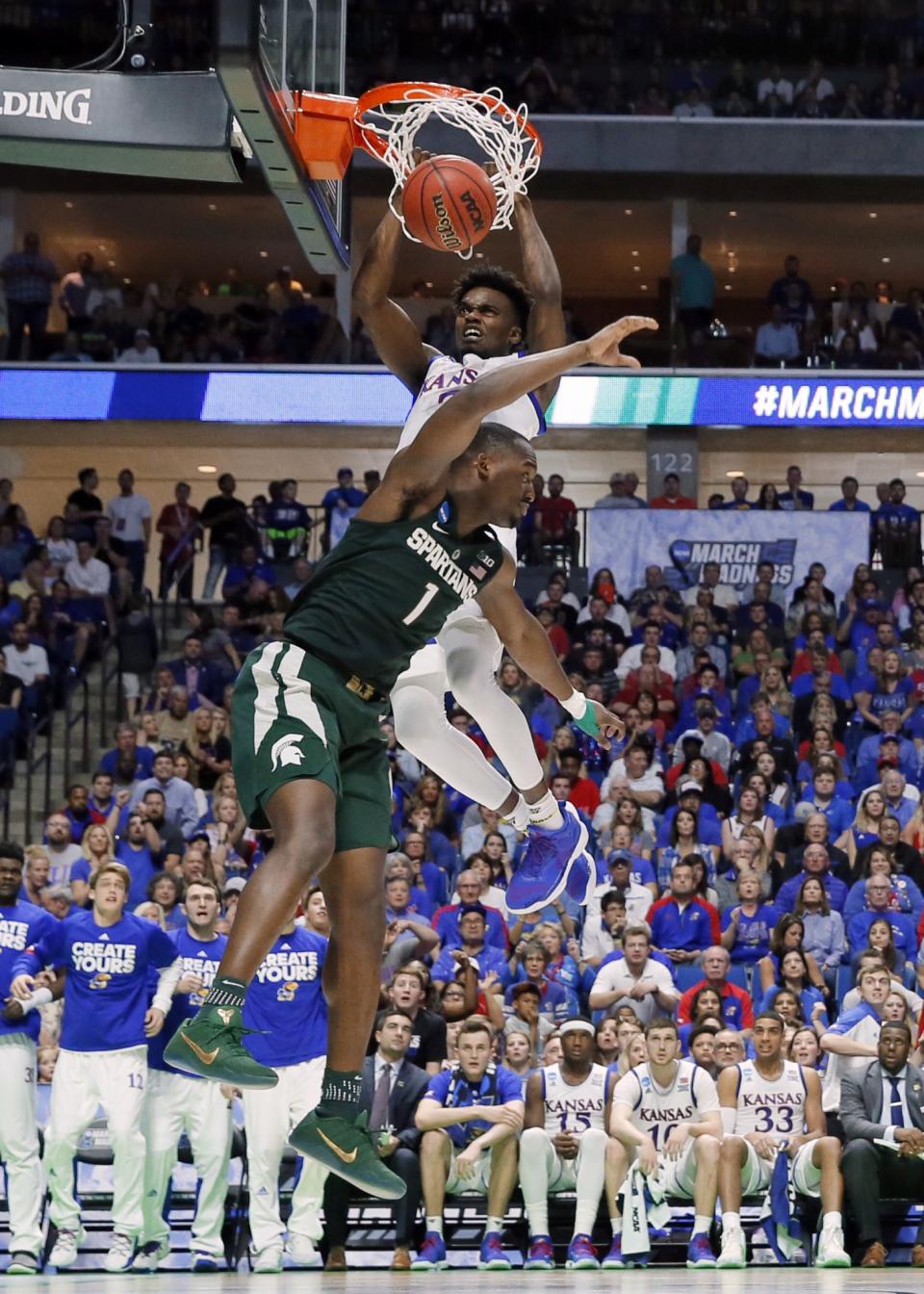 <p>Kansas guard Lagerald Vick (2) dunks the ball over Michigan State’ Joshua Langford (1) in the second half of a second-round game in the men’s NCAA college basketball tournament in Tulsa, Okla., Sunday, March 19, 2017. (AP Photo/Tony Gutierrez) </p>