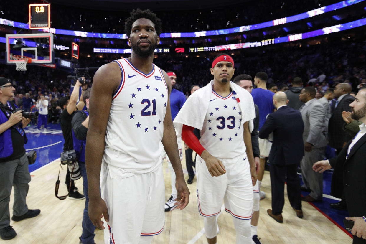 Philadelphia 76ers' Joel Embiid, left, and Tobias Harris, right, looks on following the second half of Game 6 of a second-round NBA basketball playoff series against the Toronto Raptors, Thursday, May 9, 2019, in Philadelphia. 76ers won 112-101. (AP Photo/Chris Szagola)