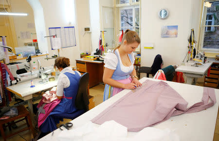 A employer tailors a traditional Dirndl dress in the Tostmann Trachtenshop in Vienna, Austria, November 25, 2016. Picture taken November 25, 2016. REUTERS/Leonhard Foeger