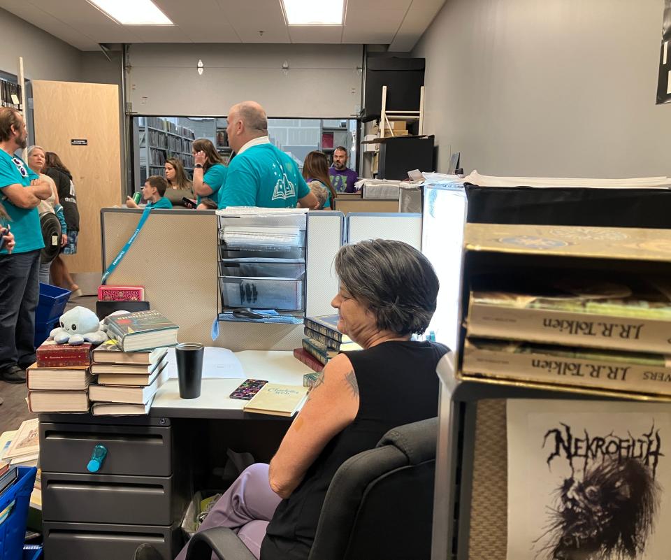 Thriftbooks employee Connie Reagan-Fly pictured at her desk on Oct. 20, 2023.