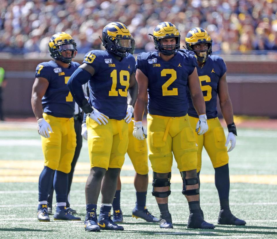 Michigan Wolverines' Kwity Paye (19), Carlo Kemp (2) and Josh Uche (6) during action against Army, Sept. 7, 2019 at Michigan Stadium.