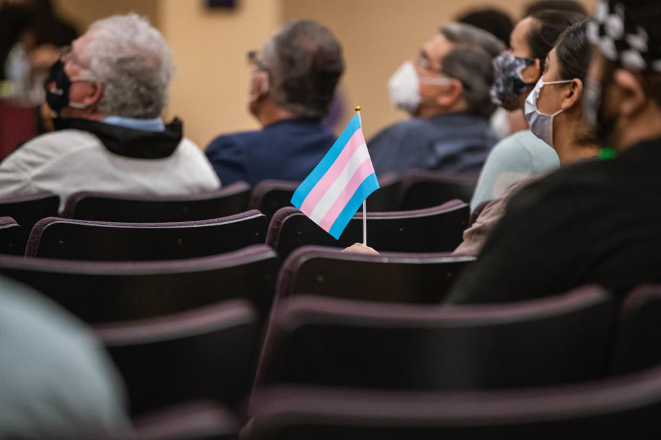 Issues around transgender people are being considered across the country including Utah and in Las Cruces, New Mexico where a transgender flag is held during a local school board meeting on Dec. 14, 2021.