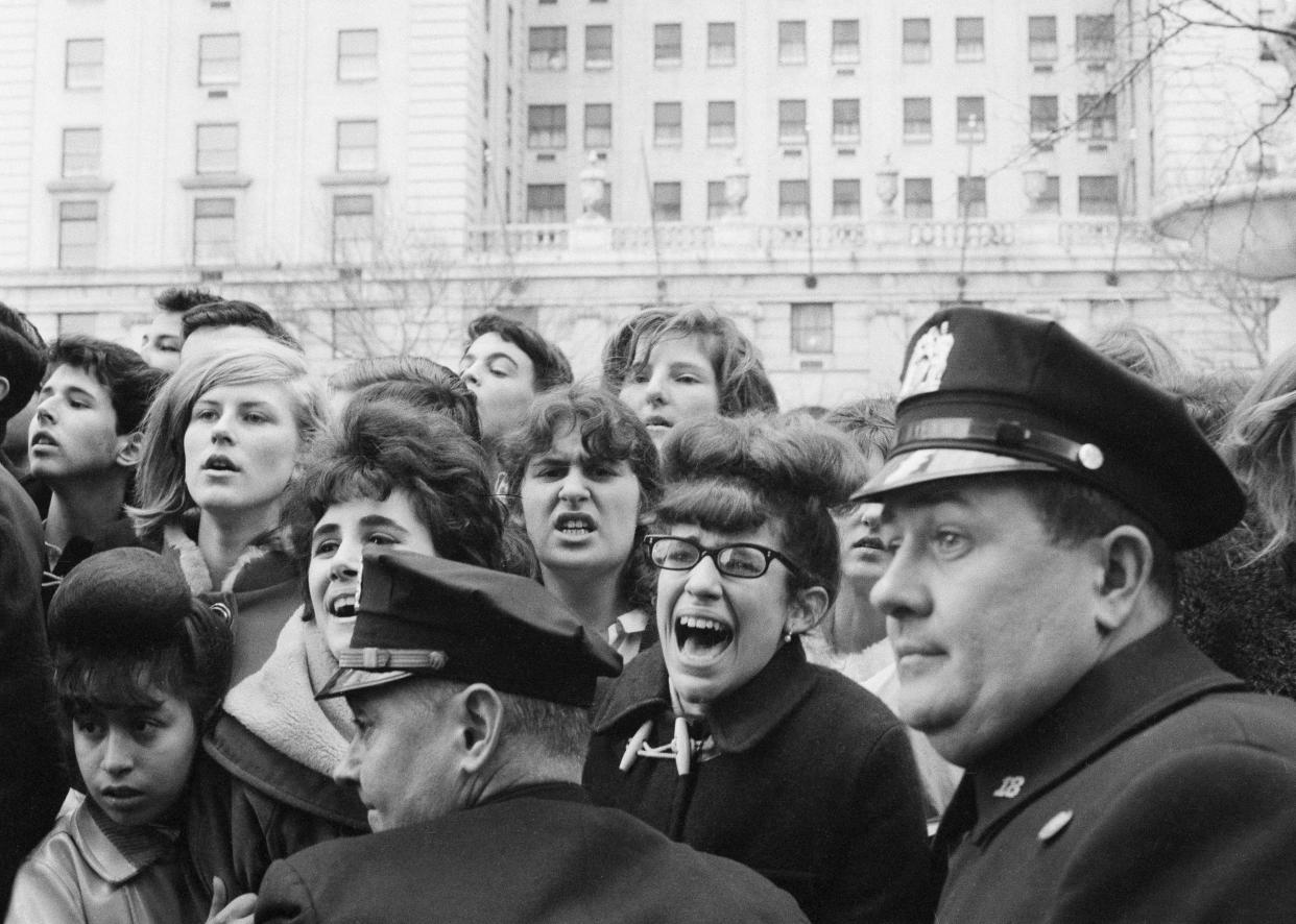 New York City police restrain young Beatles fans