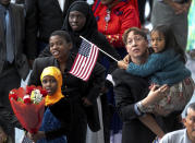 FILE - In this Sept. 20, 2017, file photo, family members welcome their relatives as new U.S. citizens after taking the citizenship oath during naturalization ceremonies at a U.S. Citizenship and Immigration Services (USCIS) ceremony in Los Angeles. A growing number of Americans say immigration should remain the same or be increased since the Trump administration ramped up immigration enforcement. That's according to the General Social Survey, which has also found a growing partisan divide on the topic. The poll shows 34 percent of Americans want immigration to be reduced, down from 41 percent in 2016. It's the first time since the question was asked in 2004 that more Americans want immigration levels to stay the same than to be reduced. (AP Photo/Damian Dovarganes, File)