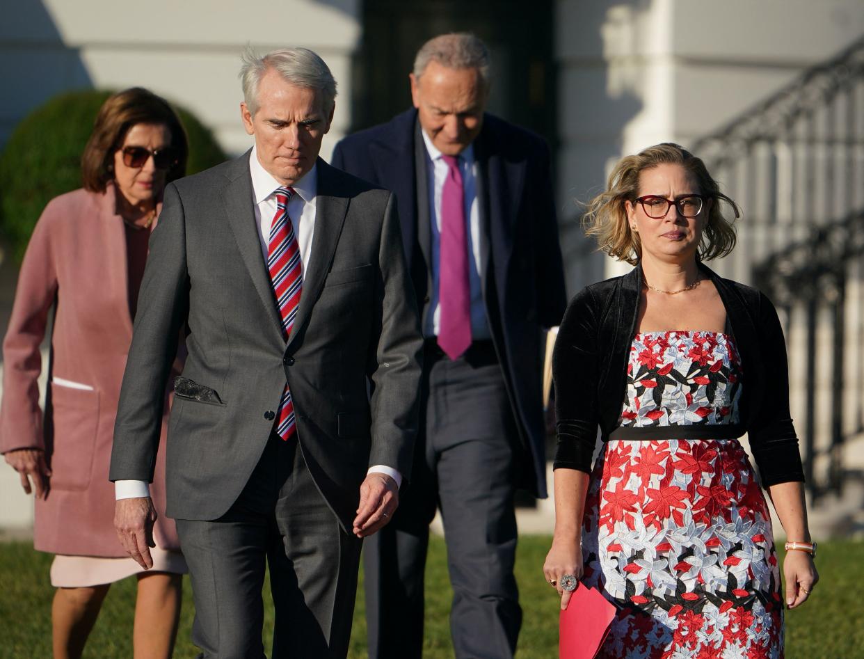 From left, House Speaker Nancy Pelosi, Sen. Rob Portman, R-Ohio, Senate Majority Leader Chuck Schumer, D-N.Y., and Sen. Kyrsten Sinema, D-Ariz