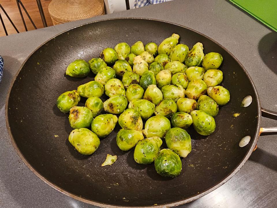 Brussels sprouts in a large wok, cooked