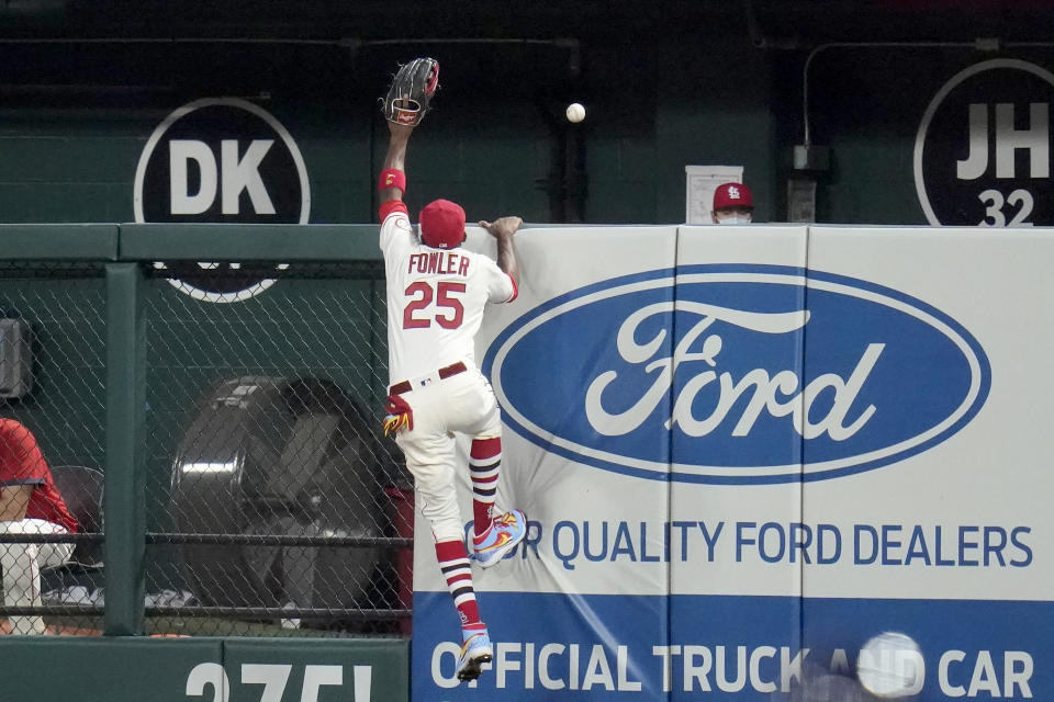 St. Louis Cardinals right fielder Dexter Fowler reaches for a solo home run by Milwaukee Brewers' Ryan Braun during the fourth inning of a baseball game Saturday, Sept. 26, 2020, in St. Louis. (AP Photo/Jeff Roberson)