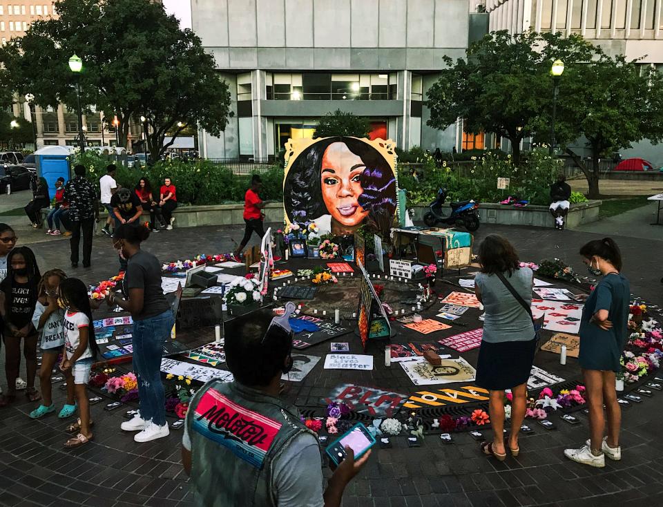 People observe the memorial for Breonna Taylor at Jefferson Square Park in Downtown Louisville, Ky., Friday evening, Sept. 4, 2020. Friday marked the 100th-straight day of people protesting to demand justice for Taylor, a 26-year-old Black woman, who was fatally shot by police in her apartment on March 13. 