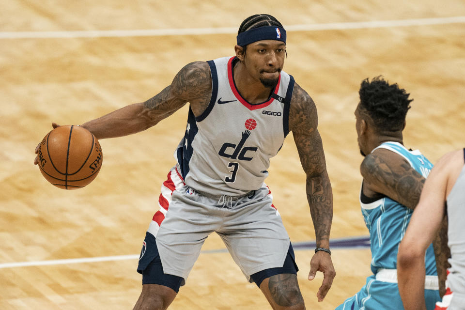 Washington Wizards guard Bradley Beal (3) brings the ball upcourt while guarded by Charlotte Hornets guard Malik Monk, right, during the first half of an NBA basketball game in Charlotte, N.C., Sunday, Feb. 7, 2021. (AP Photo/Jacob Kupferman)