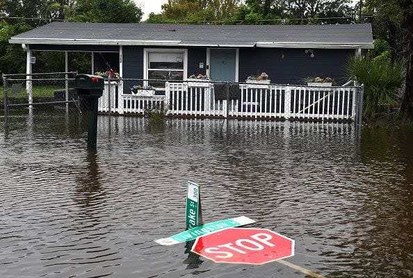 ORLANDO, FLORIDA, UNITED STATES - SEPTEMBER 29: Street signs are seen in the water in a flooded street in the aftermath of Hurricane Ian on September 29, 2022 in Orlando, Florida. The storm has caused widespread power outages and flash flooding in Central Florida as it crossed through the state after making landfall in the Fort Myers area as a Category 4 hurricane. (Photo by Paul Hennessy/Anadolu Agency via Getty Images)