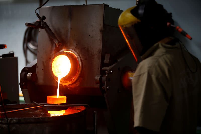 FILE PHOTO: An employee pours liquid gold into a mould for the production of an ingot during the refining process at AGR (African Gold Refinery) in Entebbe