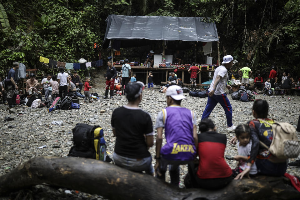 Migrants crossing the Darien Gap from Colombia to Panama, in hopes of reaching the U.S., rest at a supply spot that offers drinks for sale, Tuesday, May 9, 2023. Pandemic-related U.S. asylum restrictions, known as Title 42, are to expire Thursday, May 11. (AP Photo/Ivan Valencia)