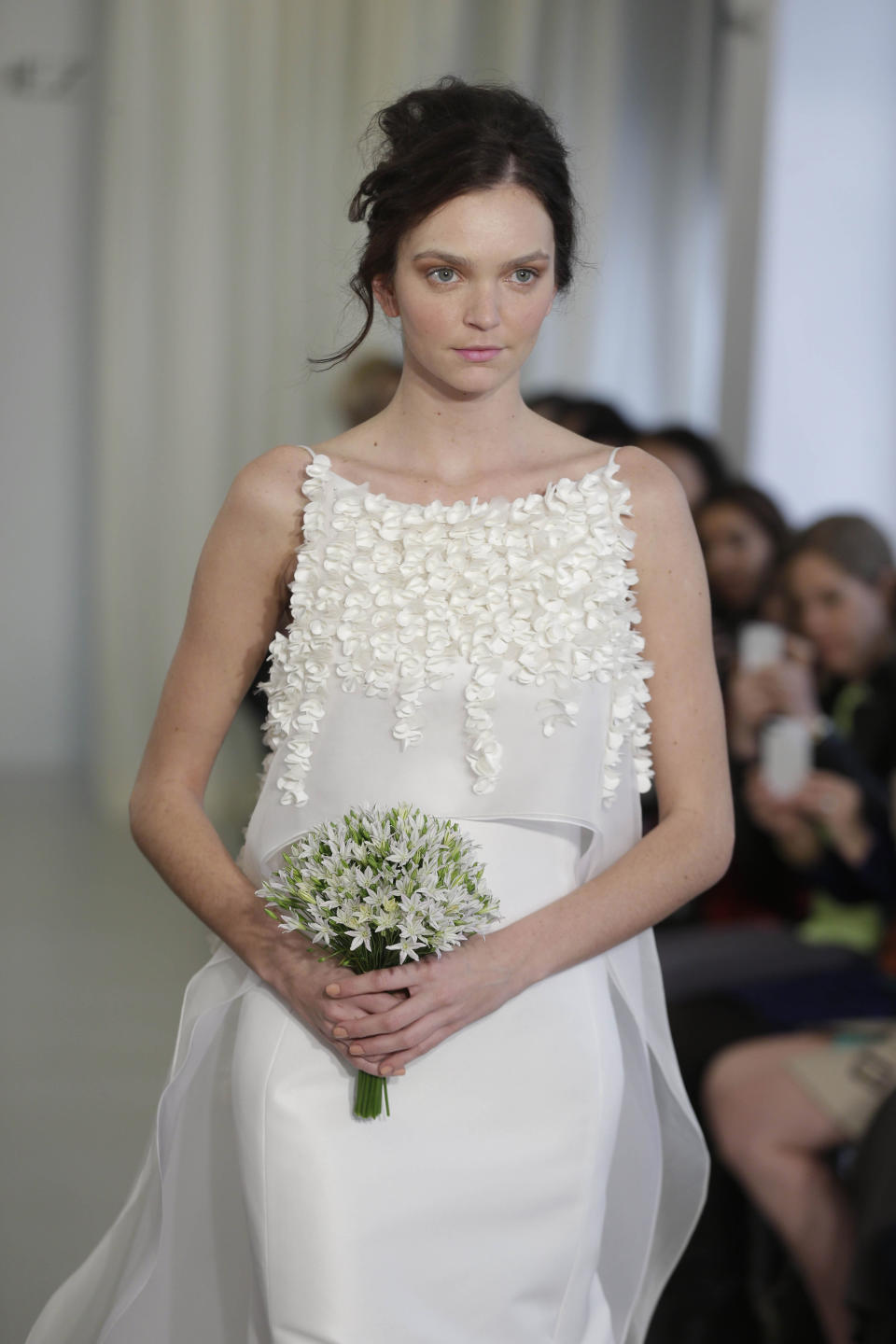 A bridal collection by Angel Sanchez is modeled in New York, Monday, April 22, 2013. (AP Photo/Seth Wenig)