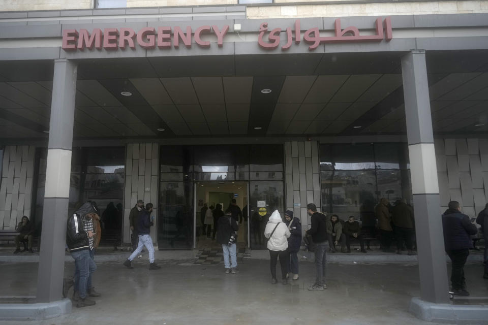 Journalists gather outside of Ibn Sina Hospital following a deadly Israeli military raid in the West Bank town of Jenin, Tuesday, Jan. 30, 2024. Armed Israeli undercover forces disguised as women and medical workers stormed the hospital on Tuesday, killing a few Palestinian militants. The Palestinian Health Ministry condemned the incursion on a hospital, where the military said the militants were hiding out. (AP Photo/Majdi Mohammed)