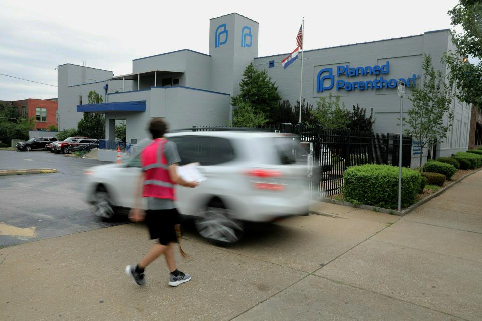 FILE - In this June 21, 2019 file photo, an anti-abortion advocate attempts to solicit a motorist entering the parking lot of the Planned Parenthood of the St. Louis Region and Southwest Missouri, the state's last operating abortion clinic in St. Louis. A Missouri judge says the state’s lone abortion clinic can continue performing abortions, at least in the near future.St. Louis Circuit Judge Michael Stelzer on Monday, June 24, 2019, ruled to extend a preliminary injunction he previously issued to allow a Planned Parenthood clinic in St. Louis to continue performing abortions through June 28. (Christian Gooden/St. Louis Post-Dispatch via AP File)