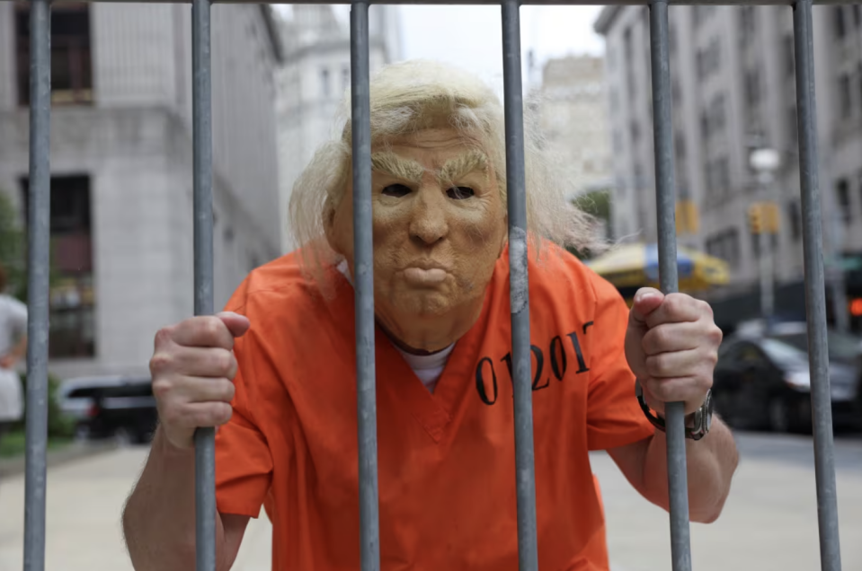 Trump in prison? Highly unlikely in this case, say most legal analysts. Seen here: a protester outside the Manhattan courthouse in 2021. (Angus Mordant/Reuters)