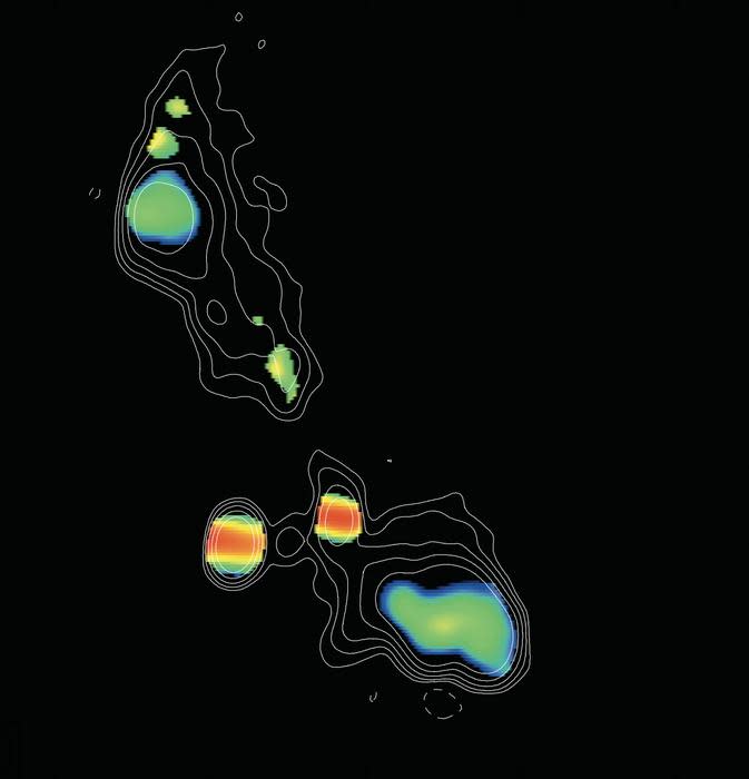 radar telescope image showing galaxies, represented as colorful clumps, against the blackness of deep space