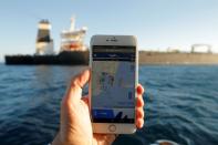 The position of the Iranian oil tanker Adrian Darya 1, formerly named Grace 1, is seen on a mobile phone as it sits anchored after the Supreme Court of the British territory lifted its detention order, in the Strait of Gibraltar